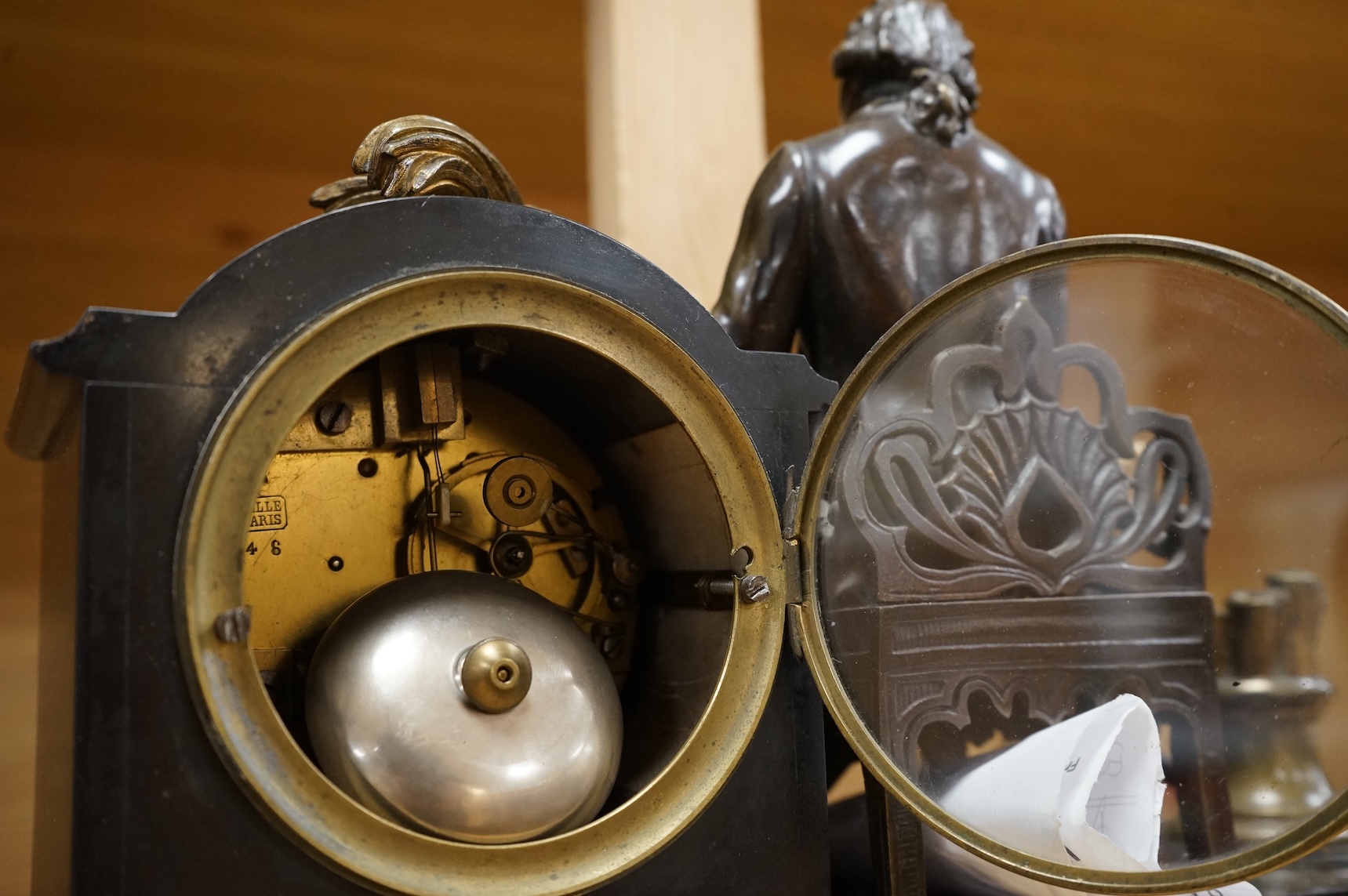 A 19th century French bronze and slate 8 day mantel clock, mounted with figure of Denis Diderot (1713-1784), 40cm wide